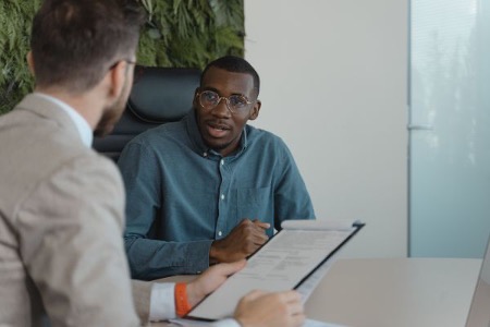 Job seeker discussing a resume with a hiring manager during an interview